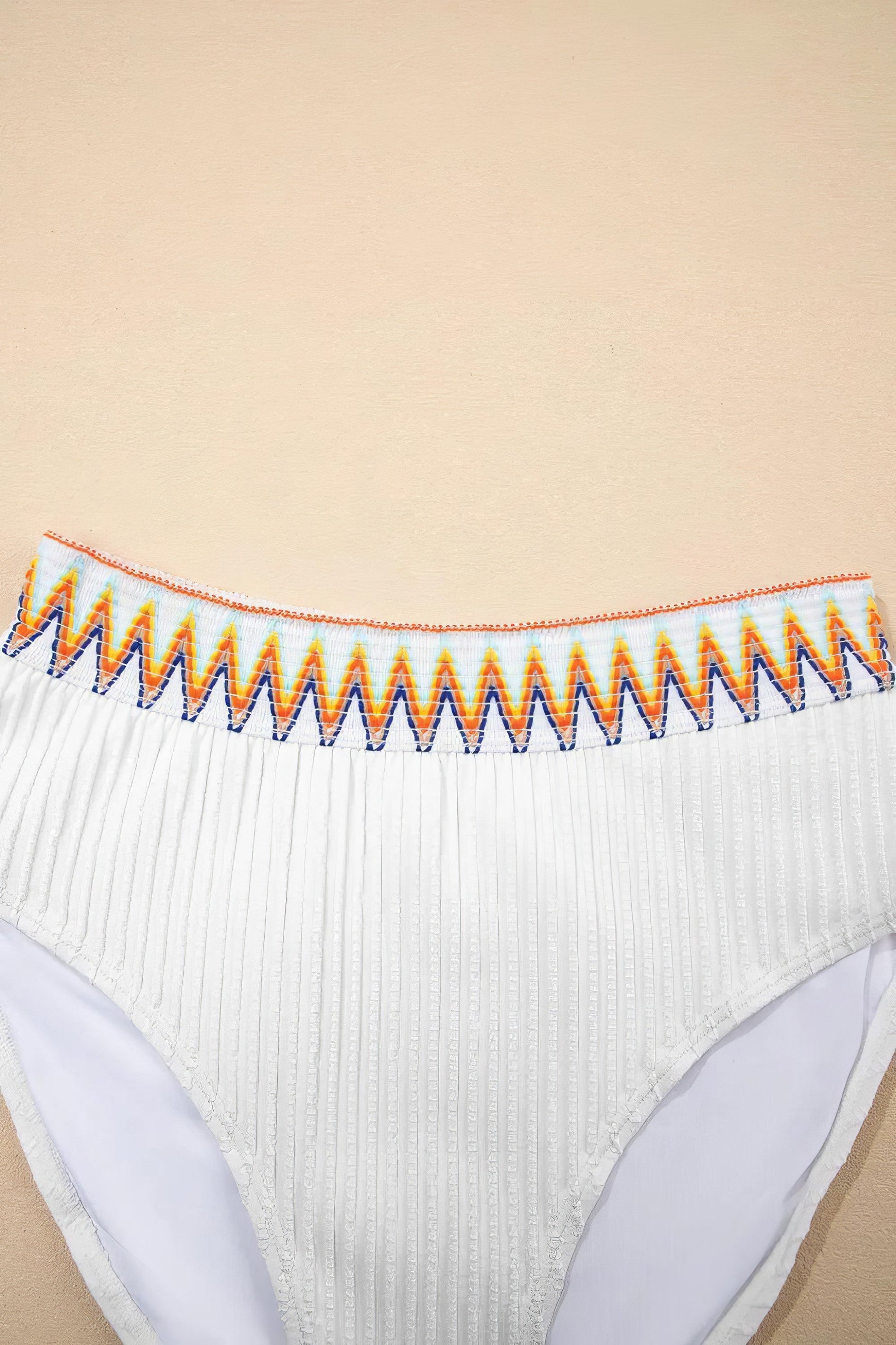 Textured contrast banding high-waist bikini swimsuit with removable padding.