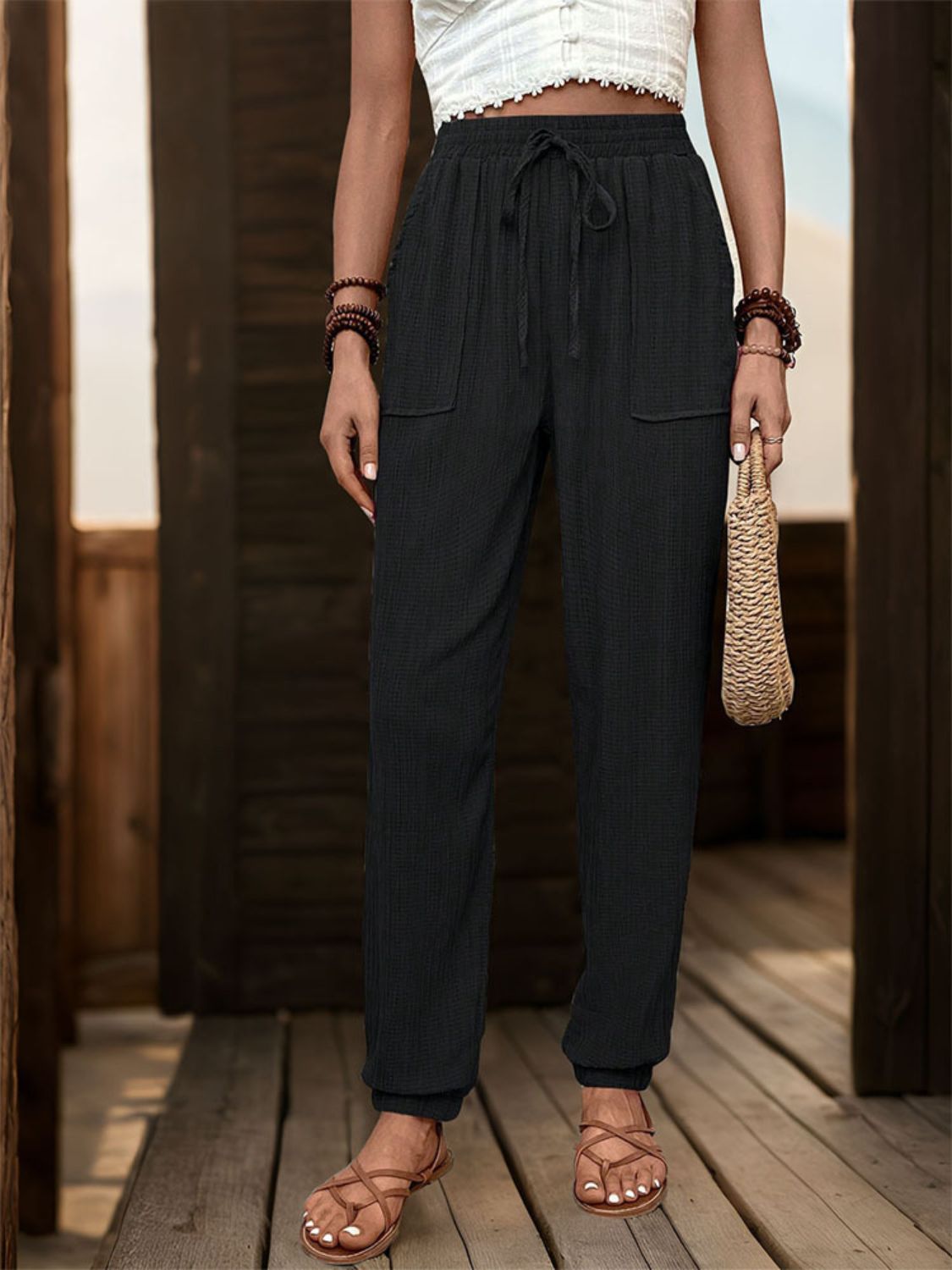 Textured high waist joggers with tie and pockets, opaque.