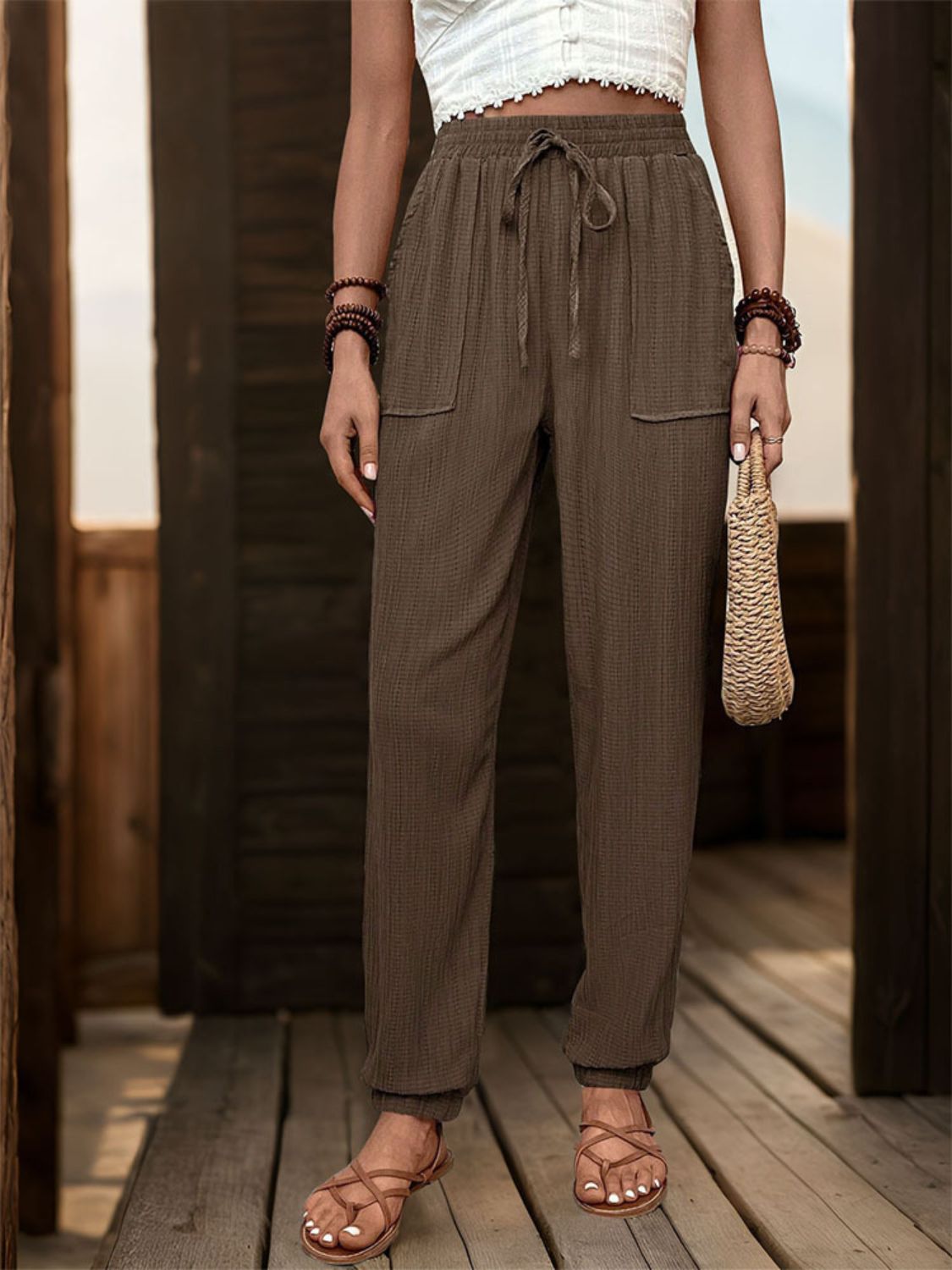 Textured high waist joggers with tie and pockets, opaque.