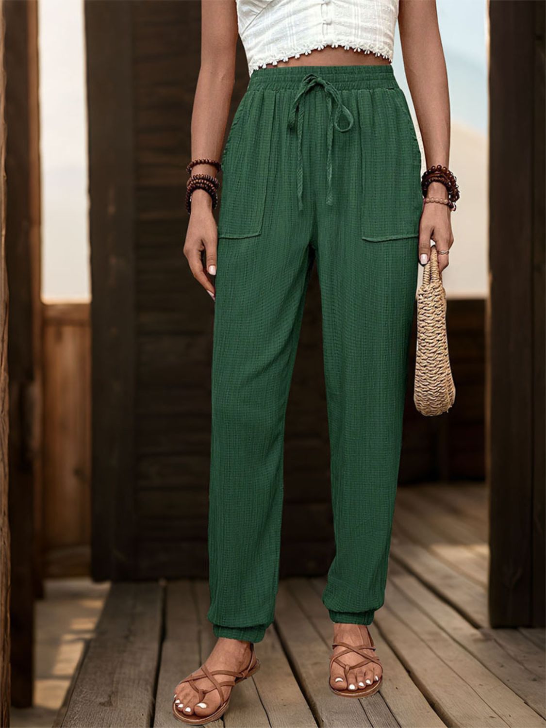 Textured high waist joggers with tie and pockets, opaque.