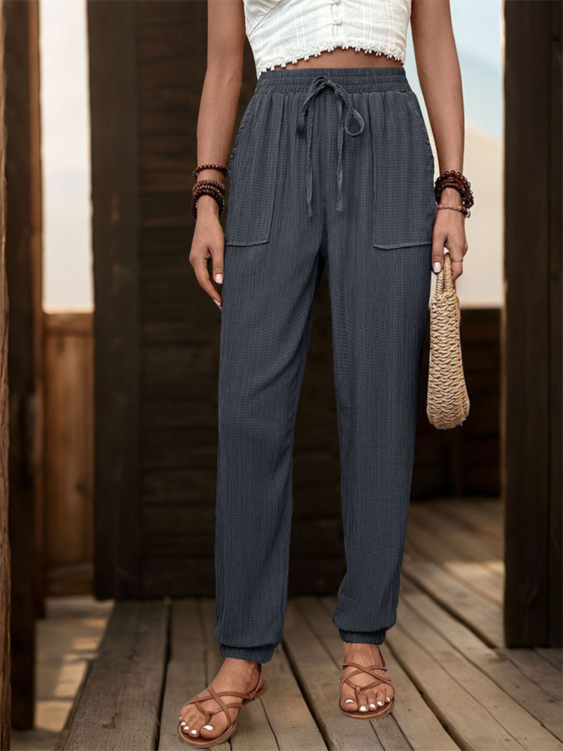 Textured high waist joggers with tie and pockets, opaque.