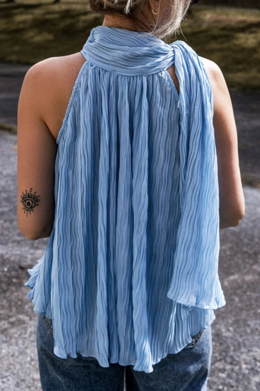 Textured pleated tied mock neck flowy tank top.
