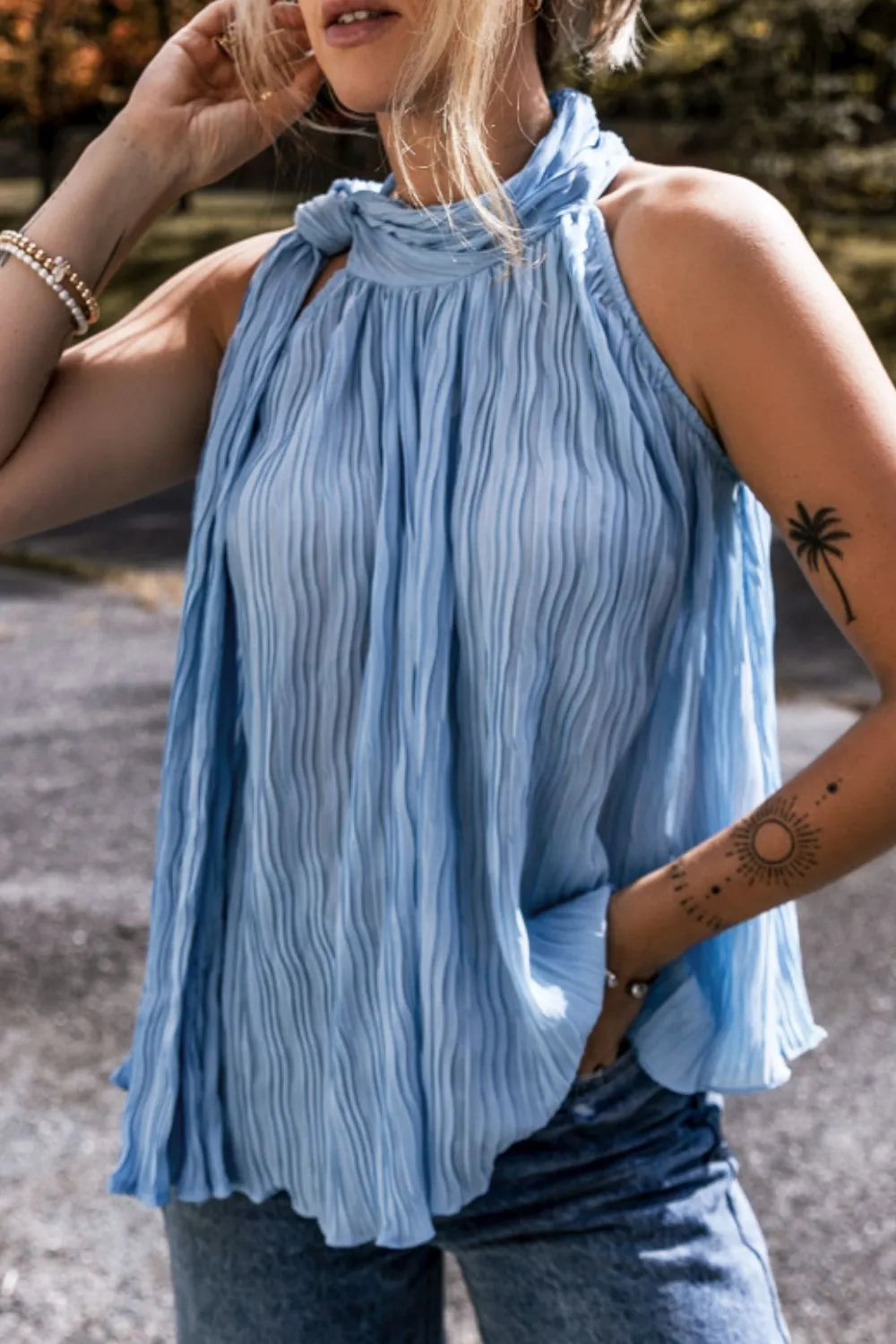 Textured pleated tied mock neck flowy tank top.