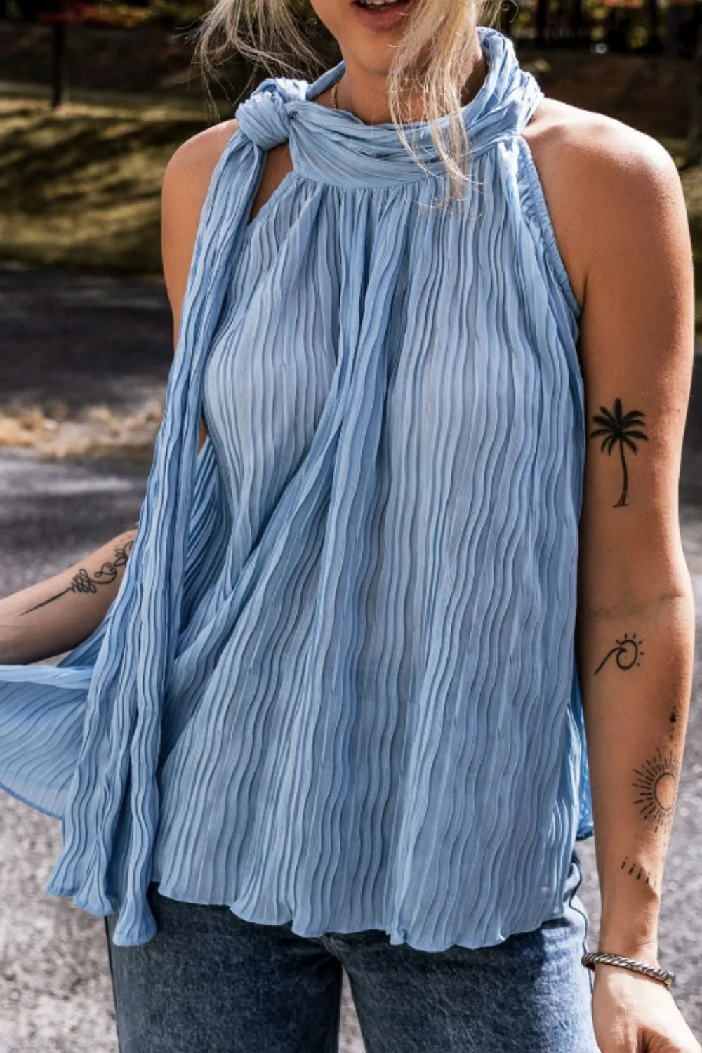 Textured pleated tied mock neck flowy tank top.