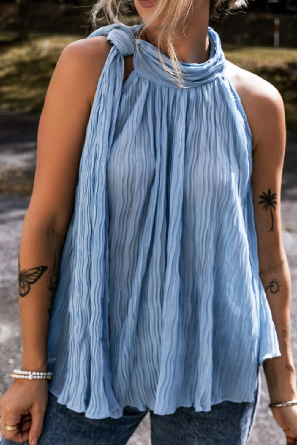 Textured pleated tied mock neck flowy tank top.