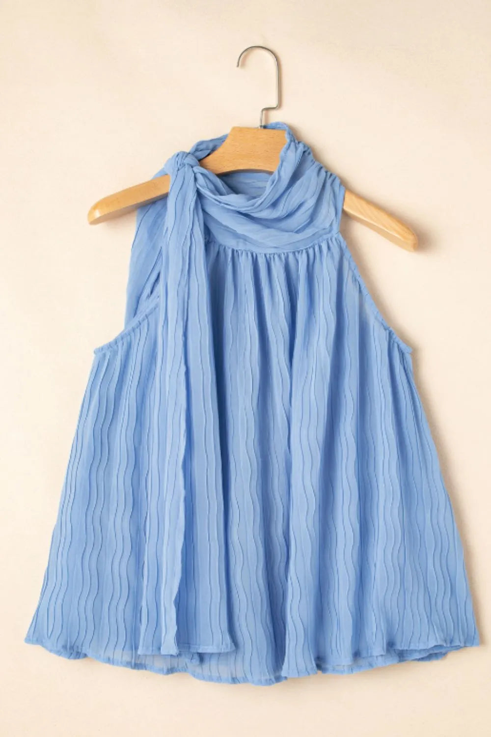 Textured pleated tied mock neck flowy tank top.