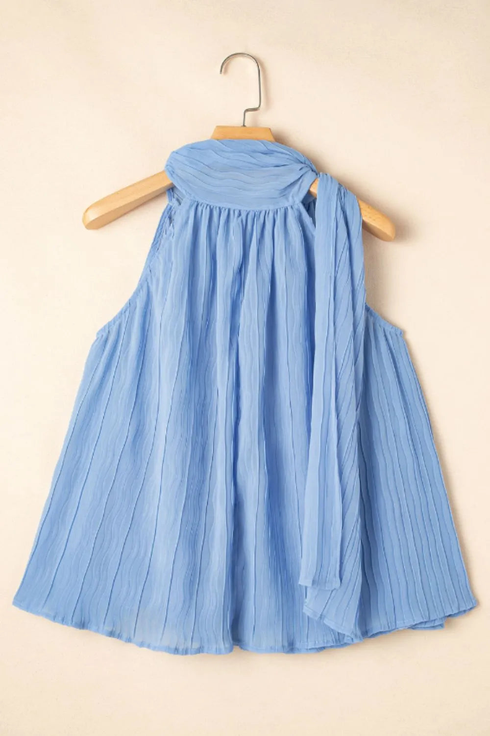 Textured pleated tied mock neck flowy tank top.