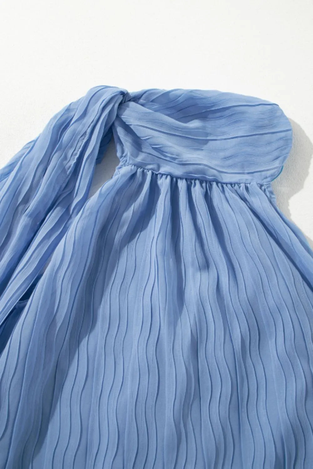 Textured pleated tied mock neck flowy tank top.