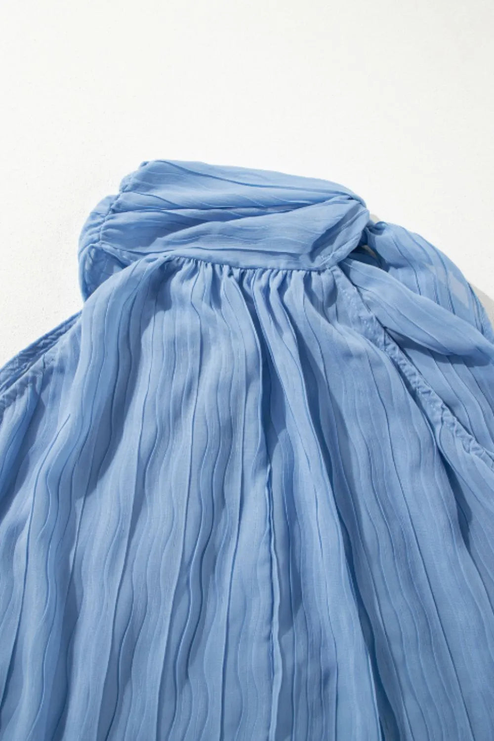 Textured pleated tied mock neck flowy tank top.