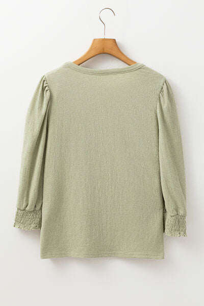 Textured Round Neck Three-Quarter Sleeve Blouse.