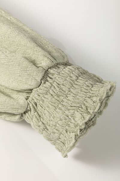 Textured Round Neck Three-Quarter Sleeve Blouse.