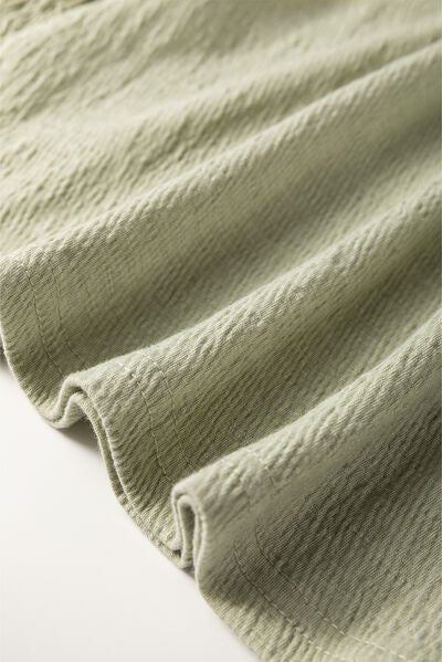 Textured Round Neck Three-Quarter Sleeve Blouse.