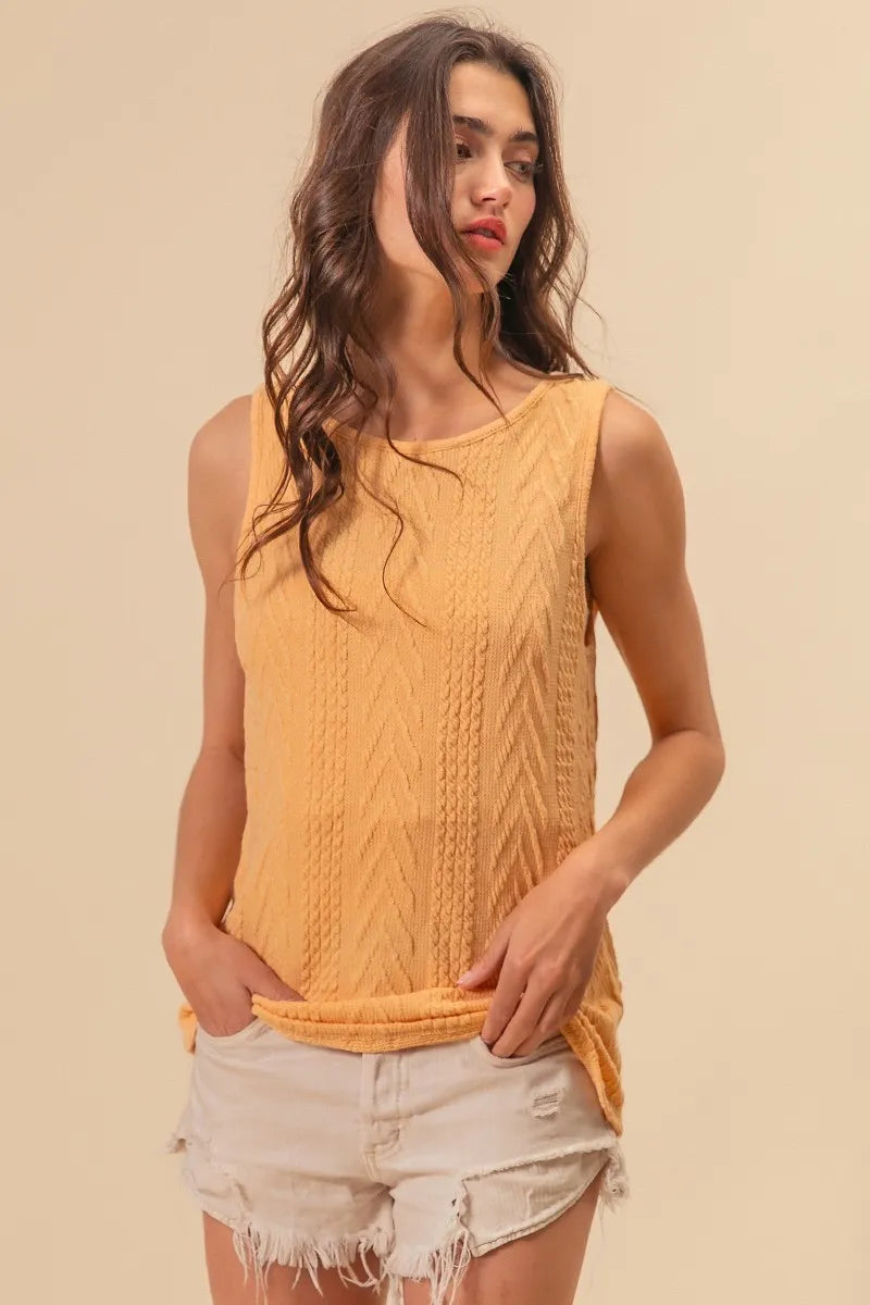 Textured sweater knit twist back sleeveless top with cable-knit design, slightly stretchy.