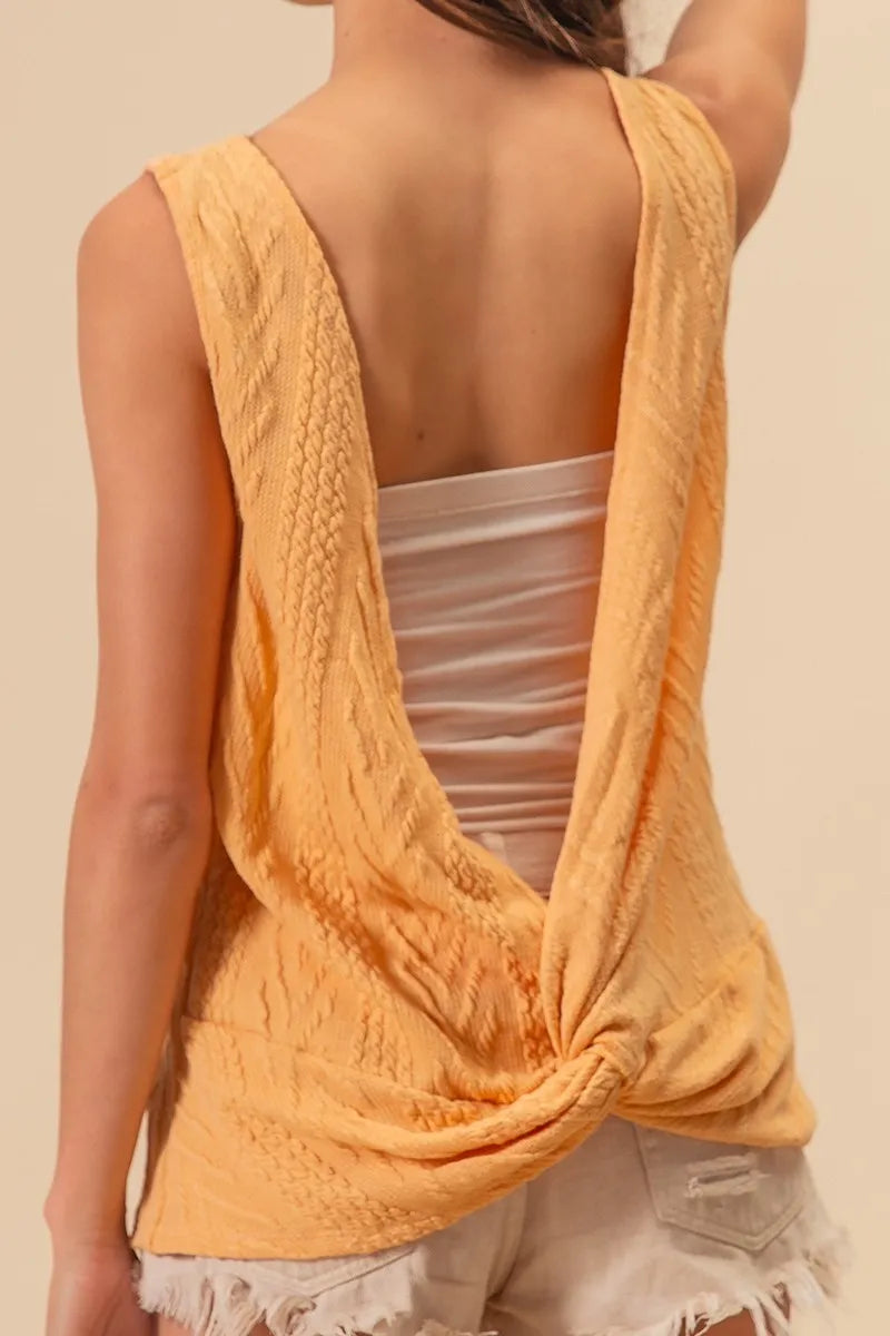 Textured sweater knit twist back sleeveless top with cable-knit design, slightly stretchy.