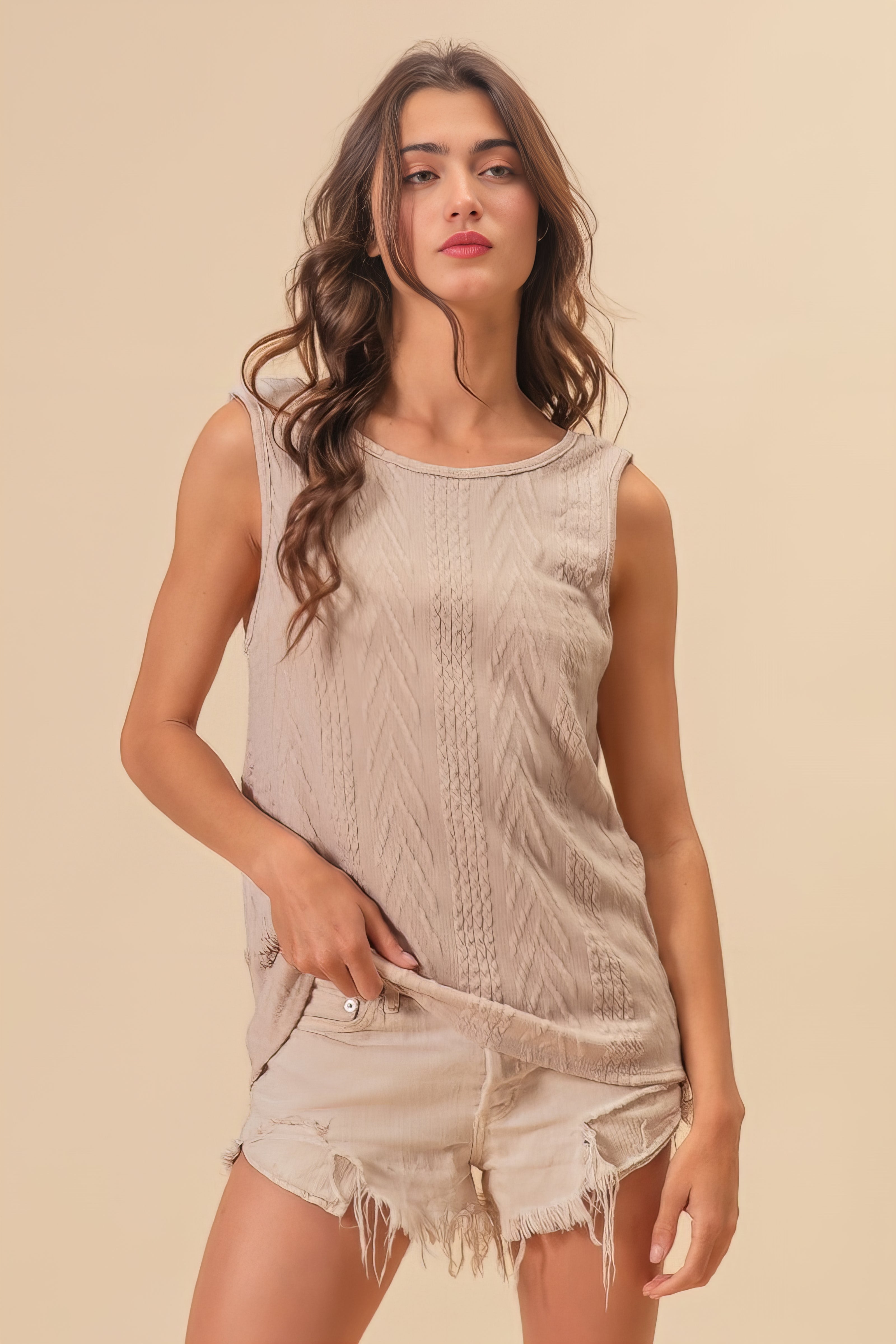 Textured sweater knit twist back sleeveless top with cable-knit design, slightly stretchy.