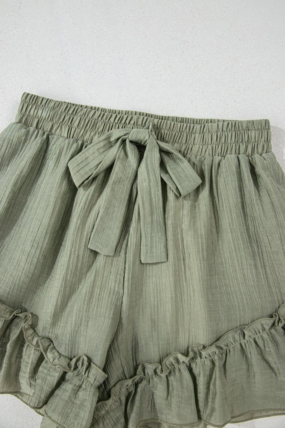 High-waist V-front Bermuda denim shorts with pockets.