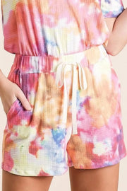 Tie dye French terry casual shorts with drawstring and pockets.