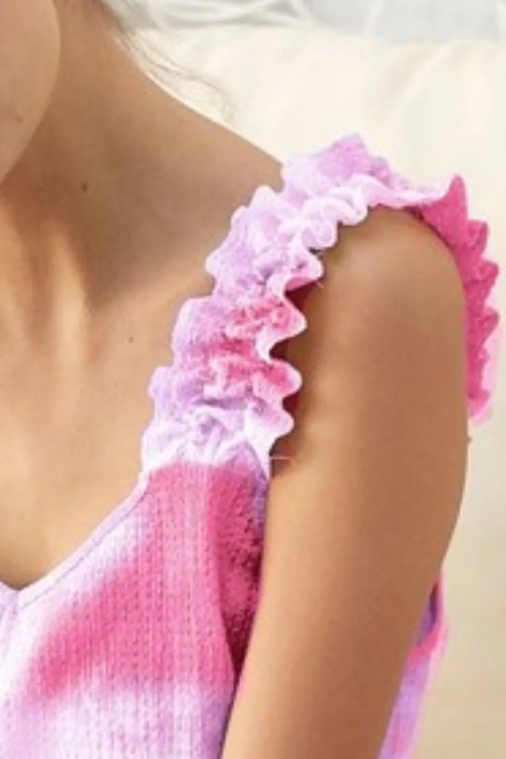 Tie dye printed textured woven top with ruffled details, slightly stretchy.