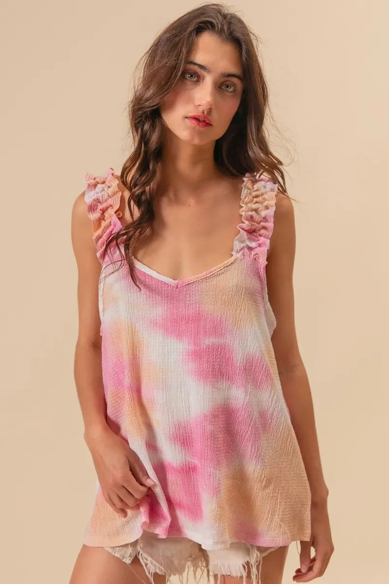 Tie dye printed textured woven top with ruffled details, slightly stretchy.