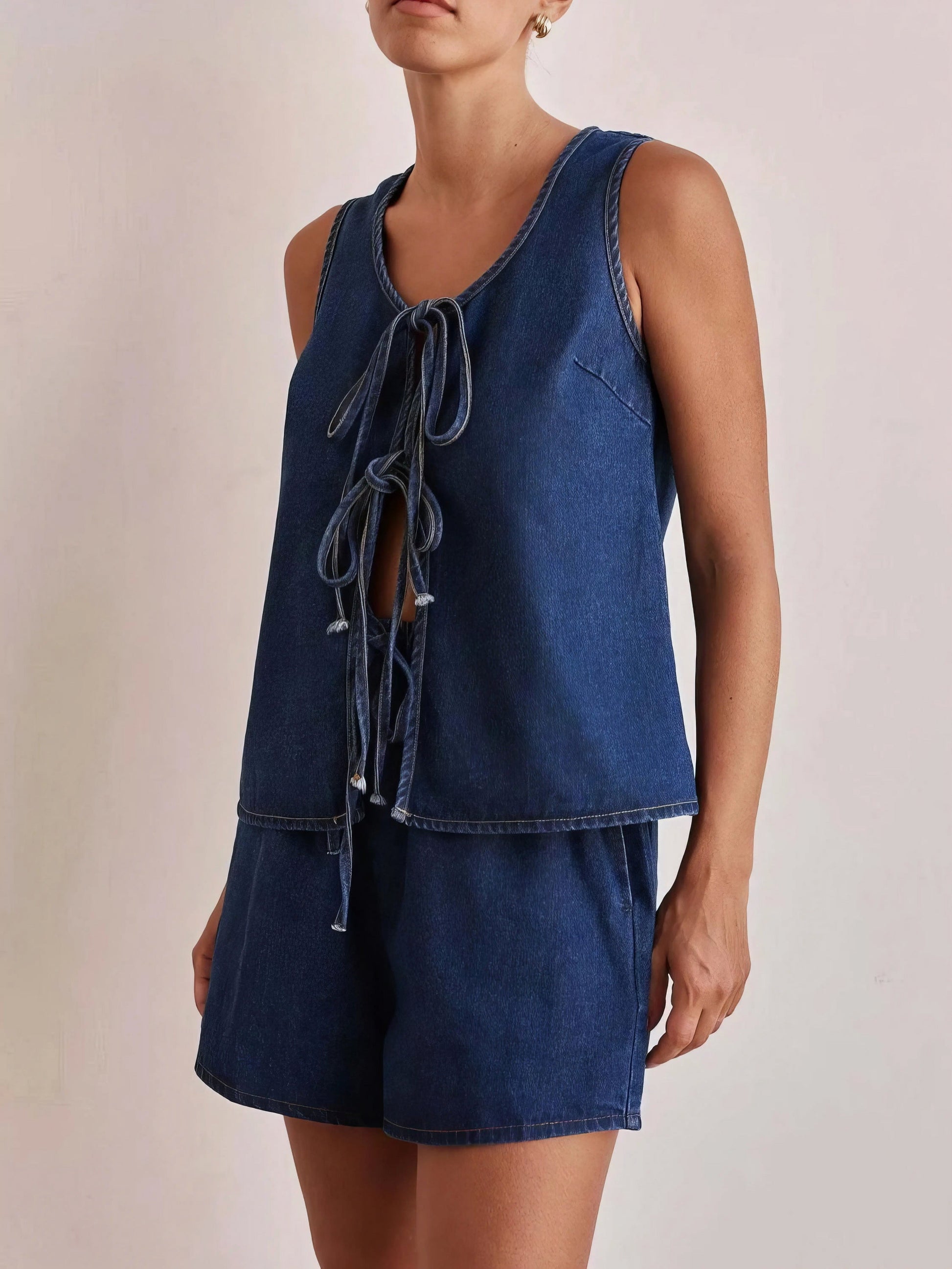 tie front vest and shorts denim set, chic edgy women's outfit, stylish two-piece set, trendy denim ensemble, comfortable vest top, fashionable denim shorts, perfect for a statement look