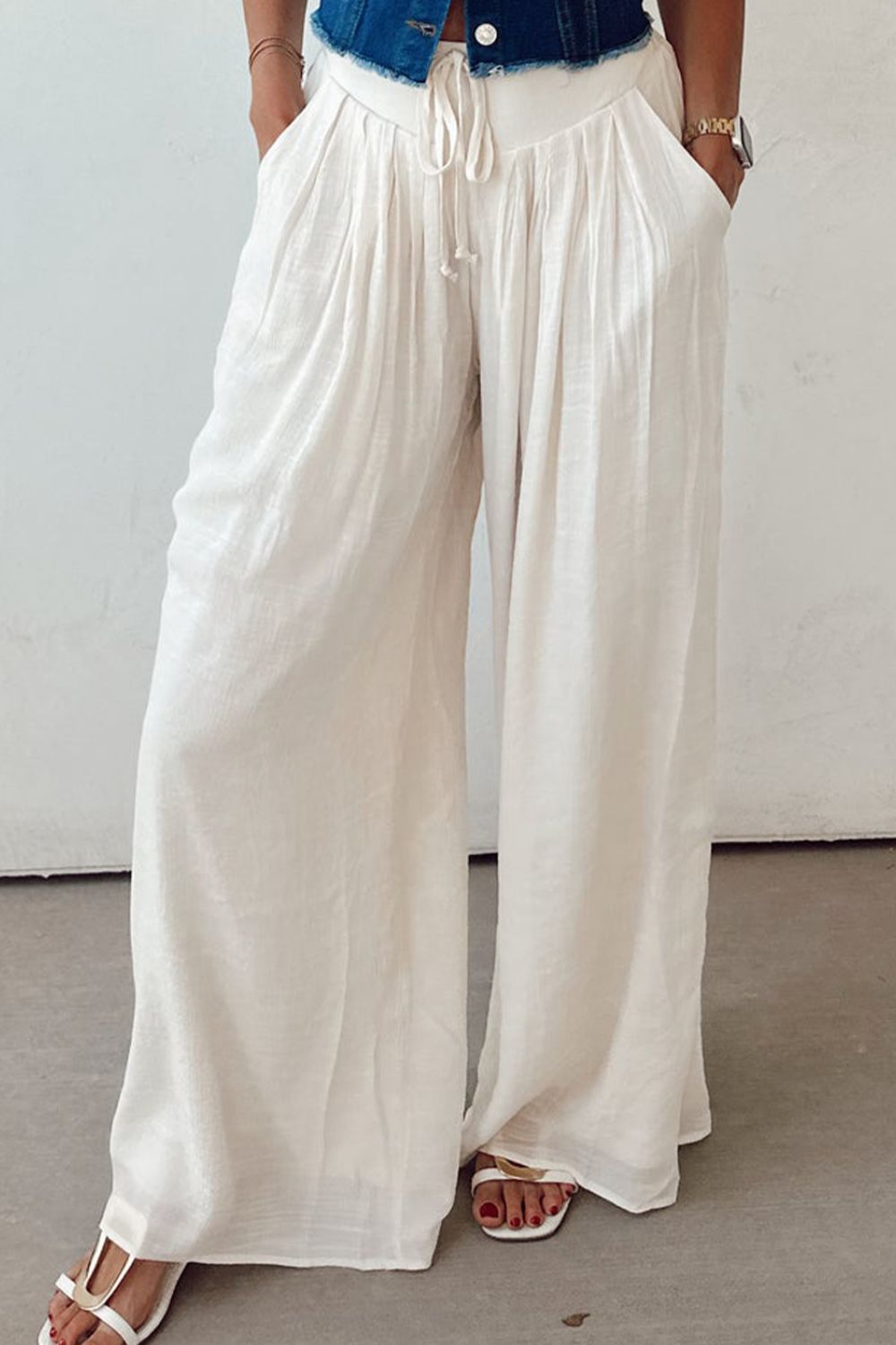 Tie waist pleated wide leg pants, opaque.