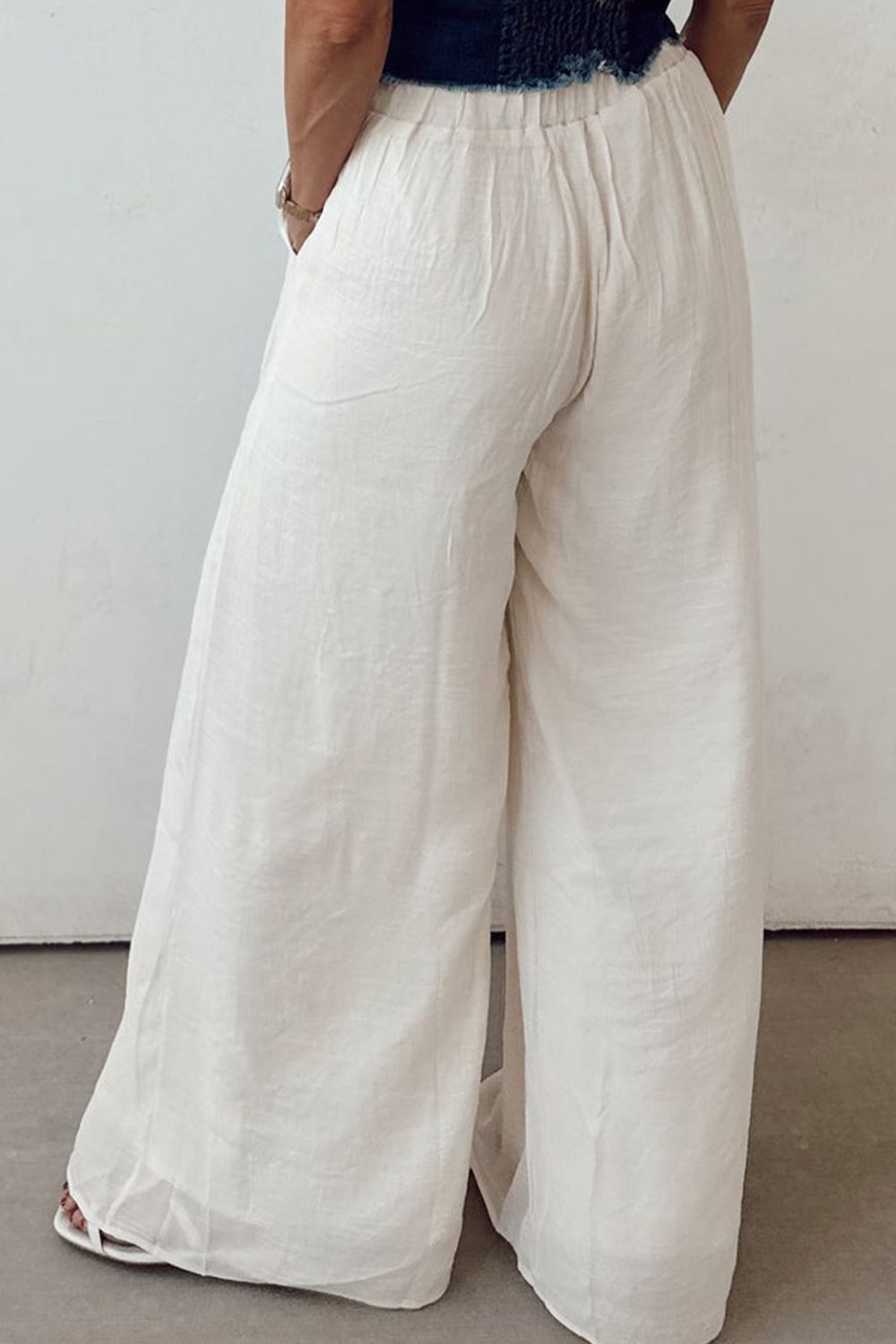Tie waist pleated wide leg pants, opaque.