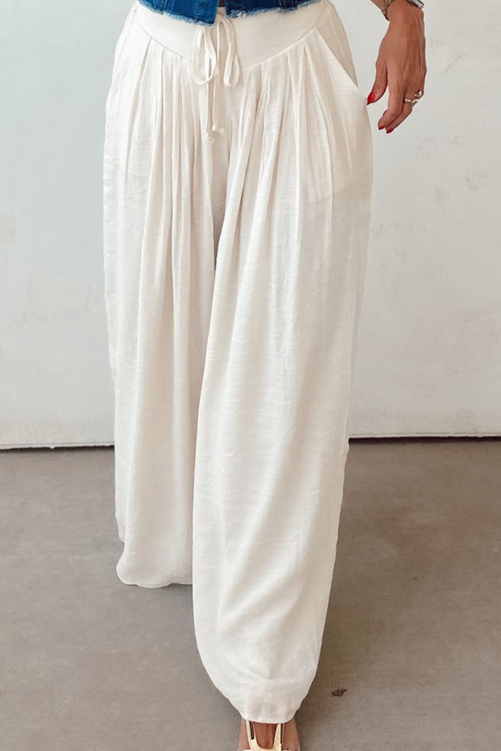 Tie waist pleated wide leg pants, opaque.