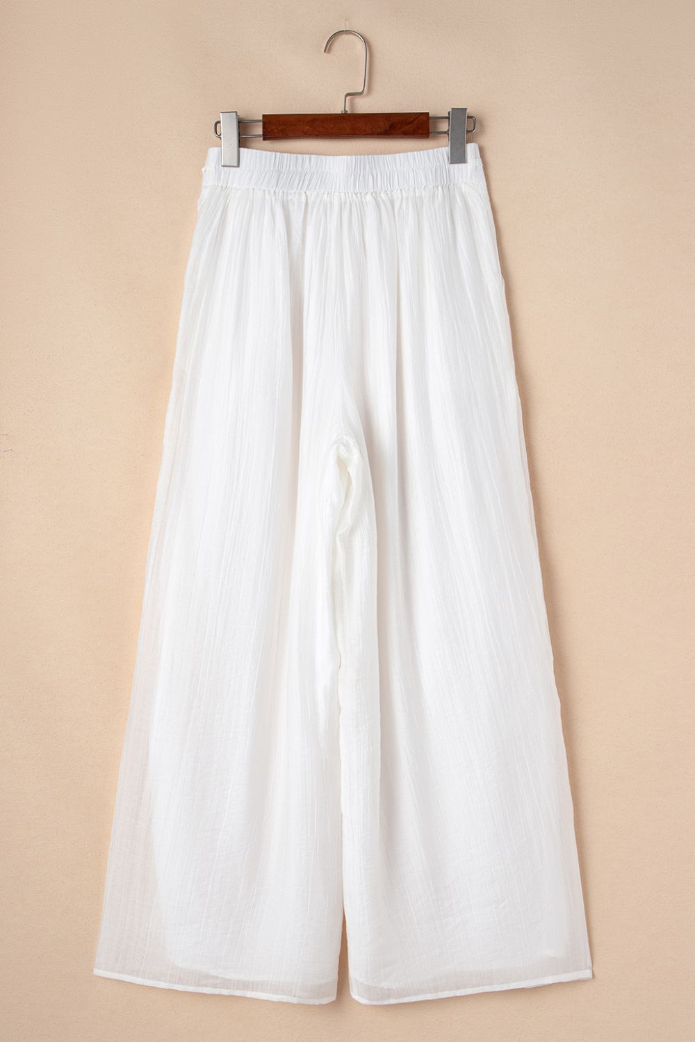 Tie waist pleated wide leg pants, opaque.