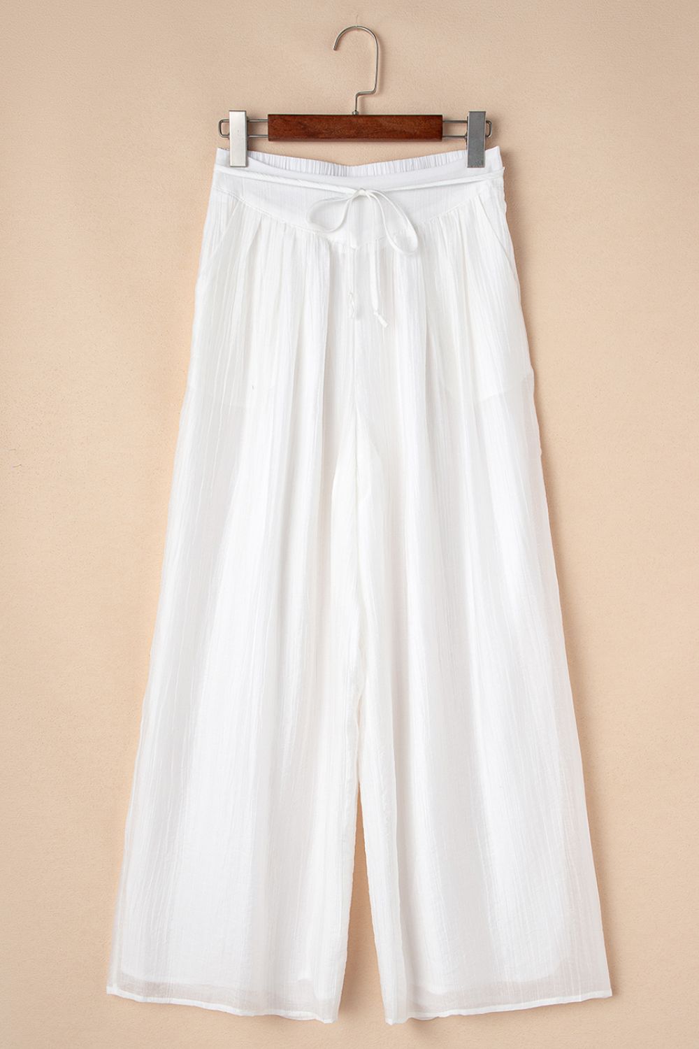Tie waist pleated wide leg pants, opaque.
