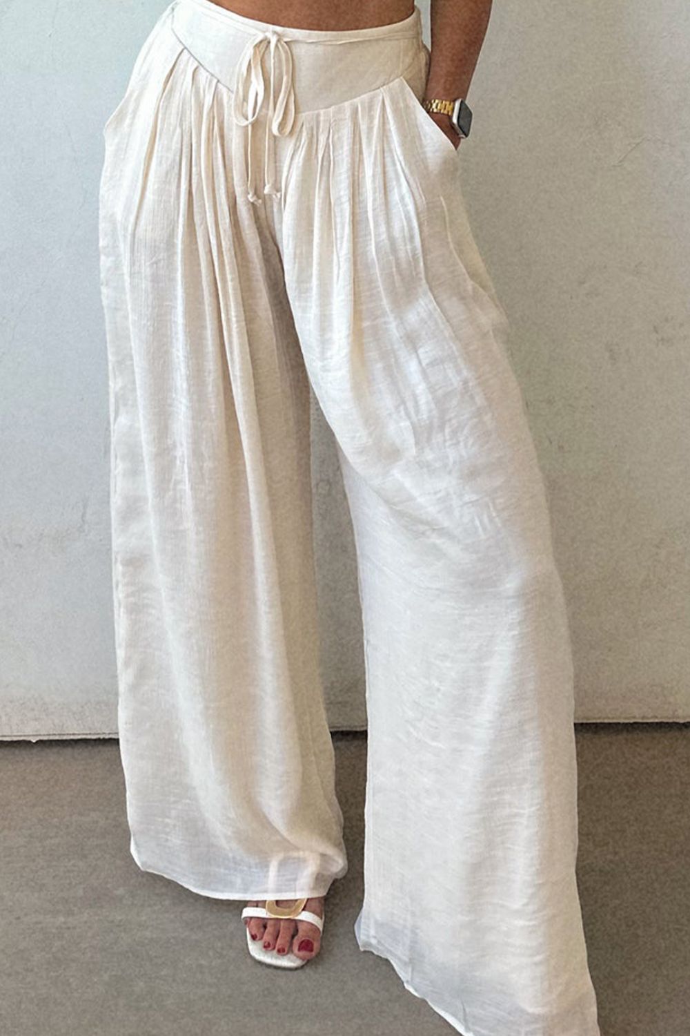 Tie waist pleated wide leg pants, opaque.