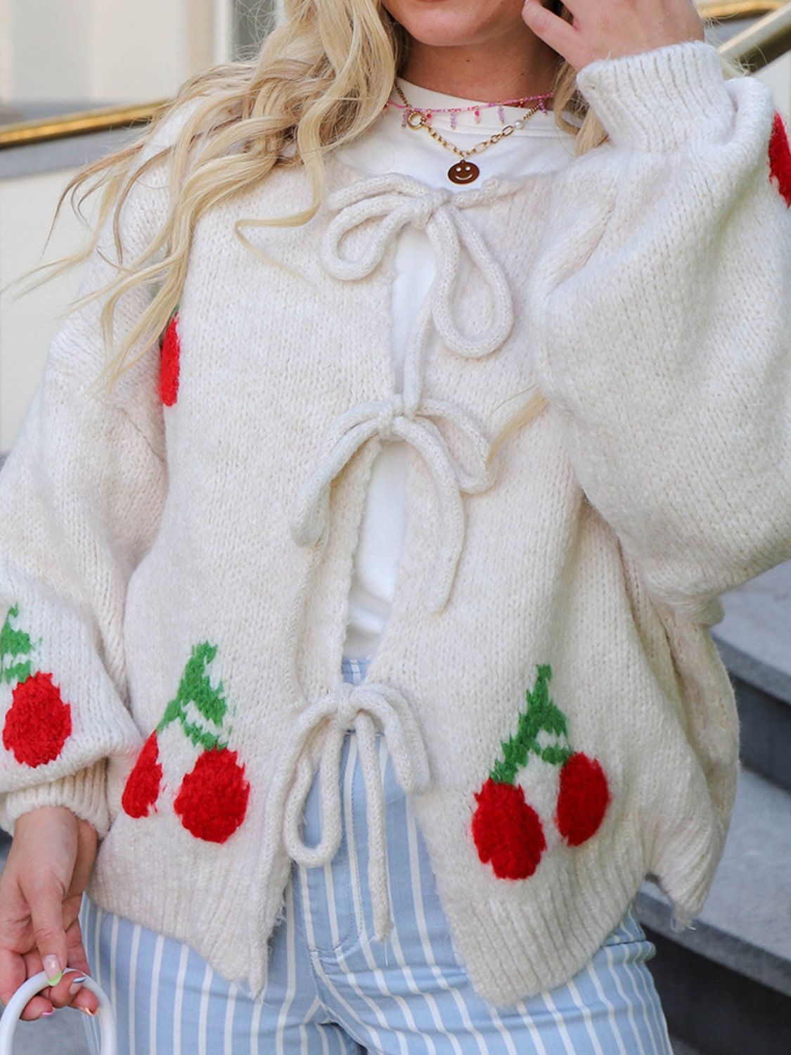 Tied cherry print round neck long sleeve cardigan.