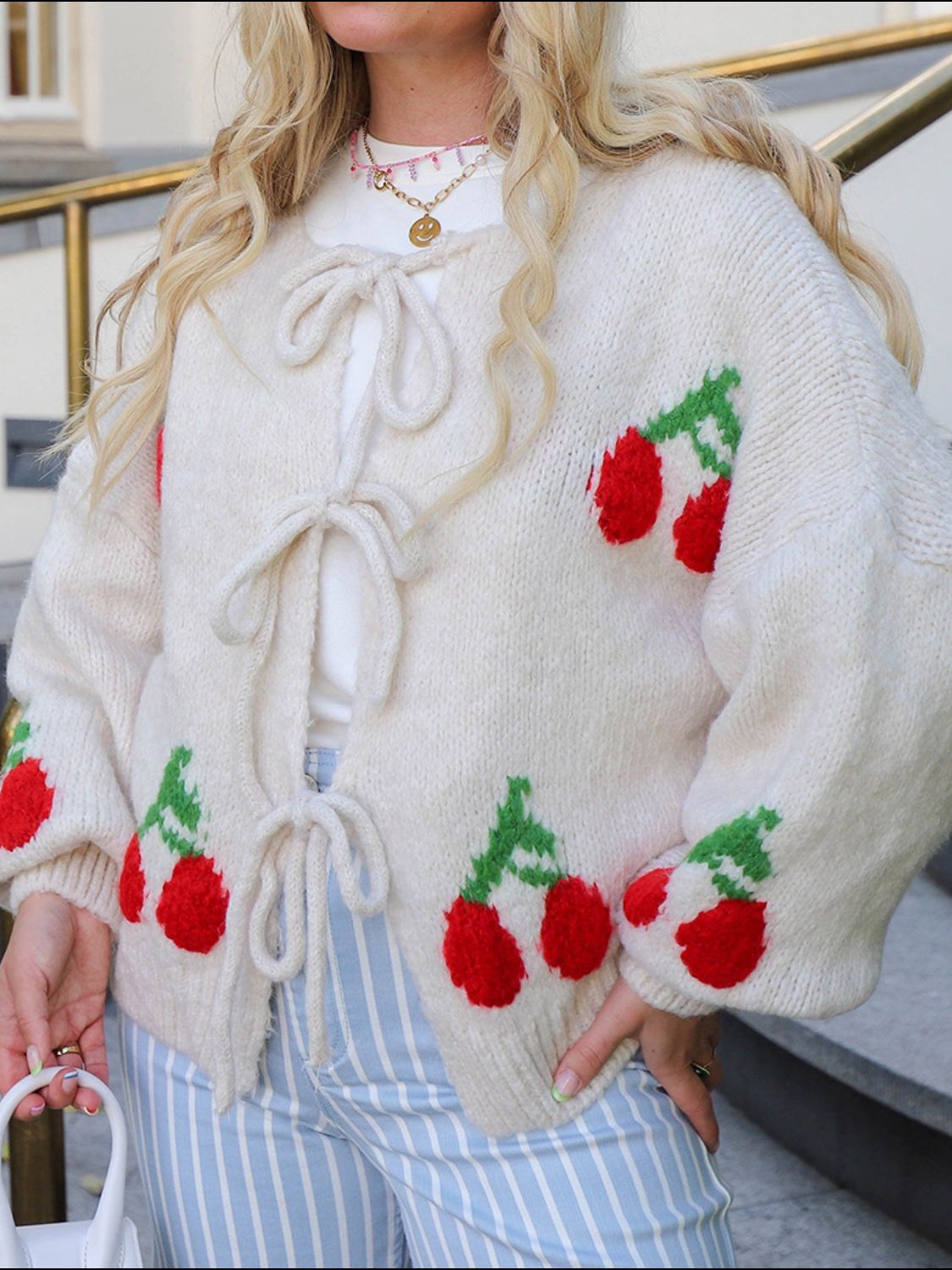 Tied cherry print round neck long sleeve cardigan.