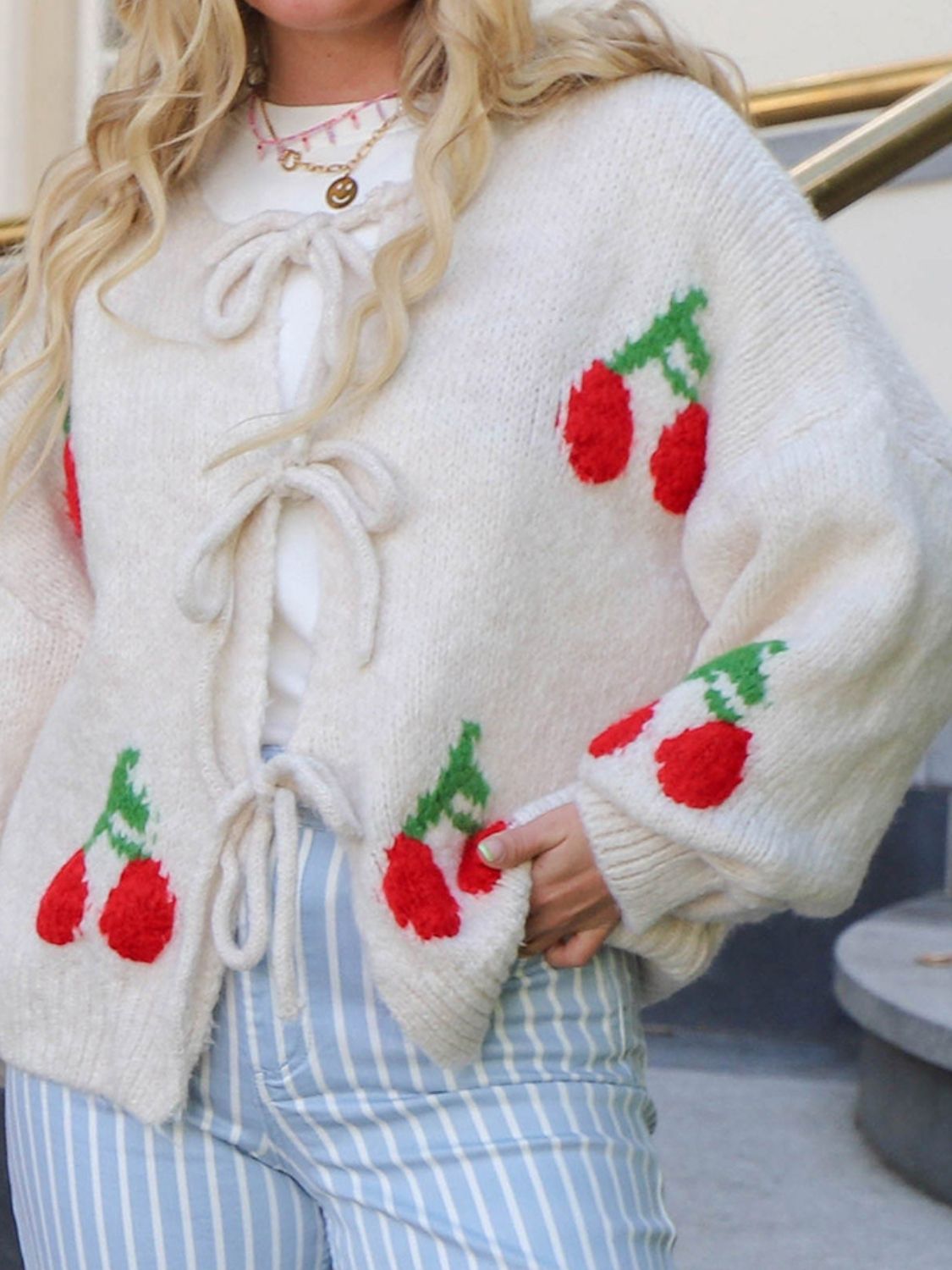 Tied cherry print round neck long sleeve cardigan.