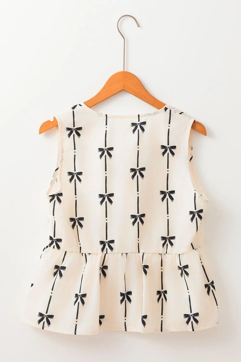 Tied front bow print peplum tank, opaque.