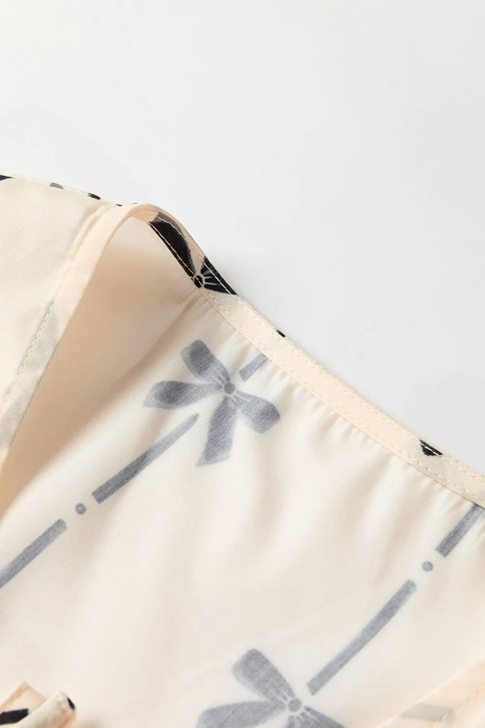 Tied front bow print peplum tank, opaque.