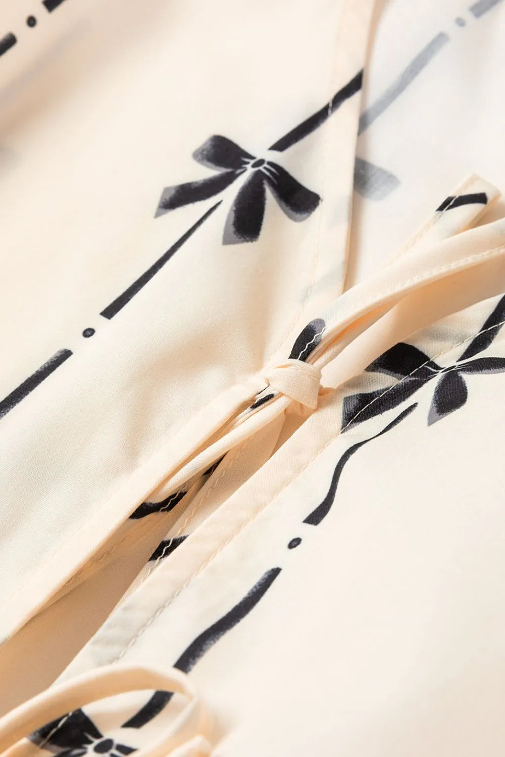 Tied front bow print peplum tank, opaque.