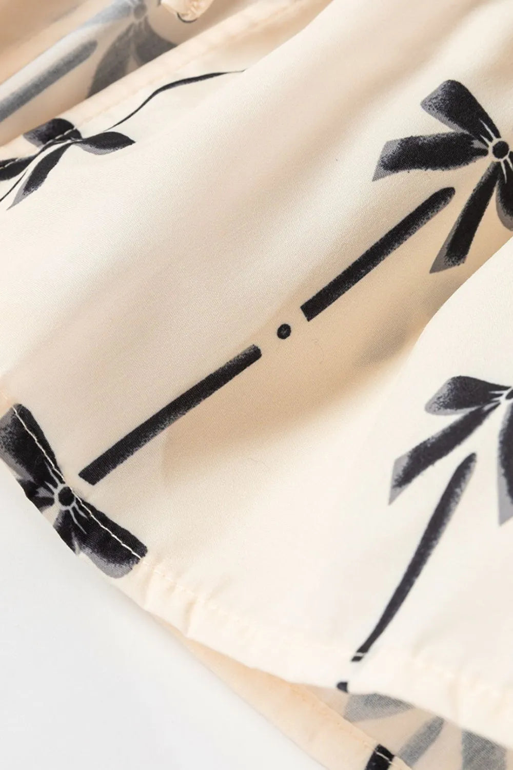 Tied front bow print peplum tank, opaque.