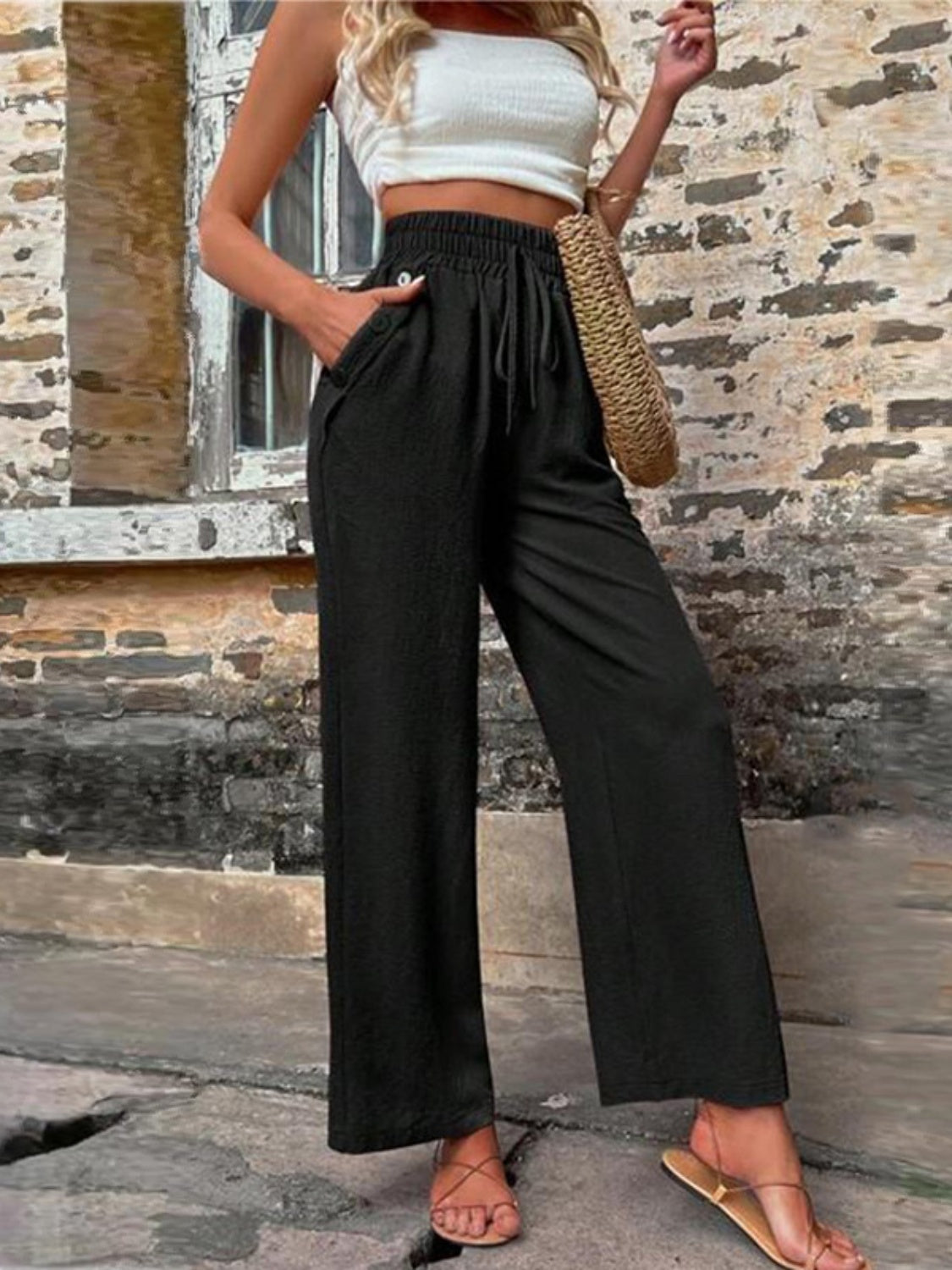 Tied high waist wide leg pants with pockets and decorative buttons, opaque.