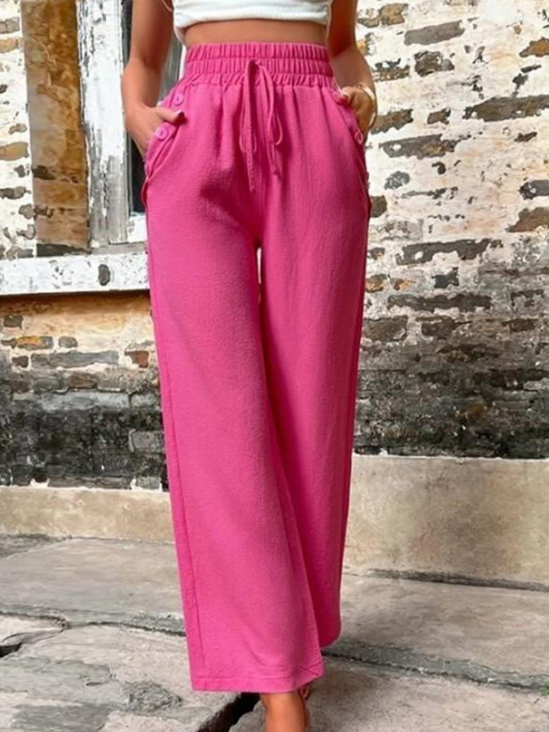 Tied high waist wide leg pants with pockets and decorative buttons, opaque.
