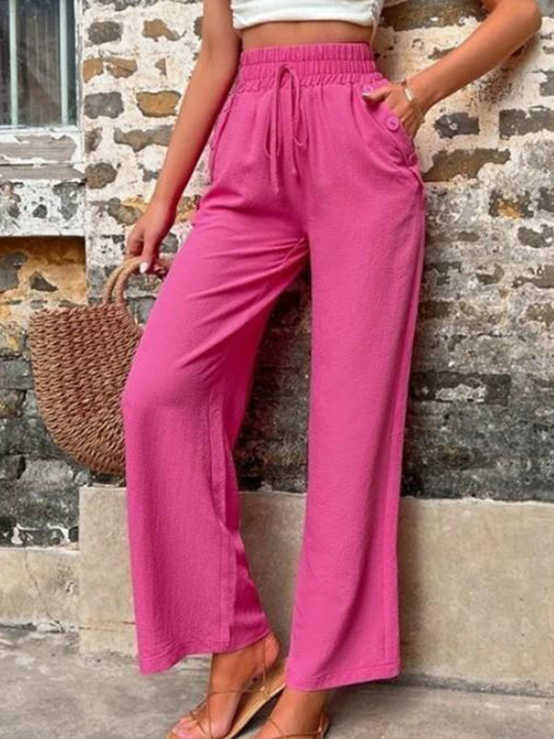Tied high waist wide leg pants with pockets and decorative buttons, opaque.
