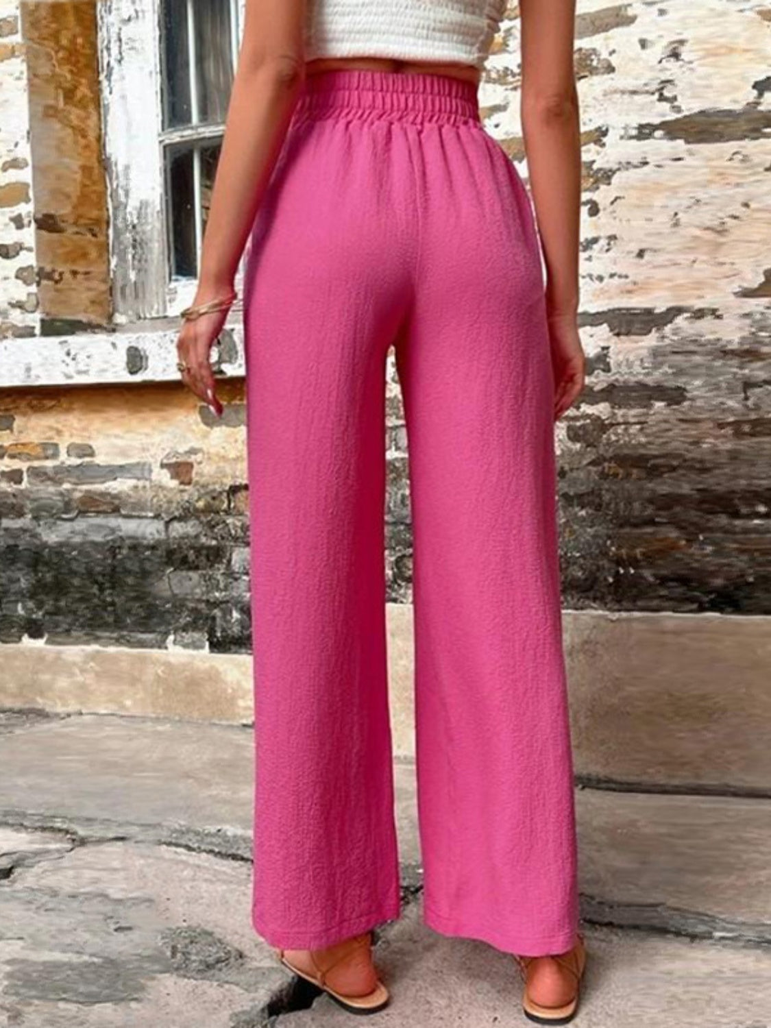 Tied high waist wide leg pants with pockets and decorative buttons, opaque.