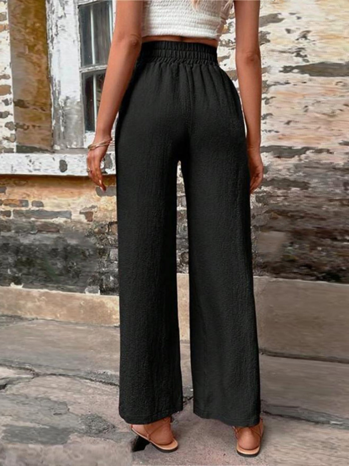 Tied high waist wide leg pants with pockets and decorative buttons, opaque.