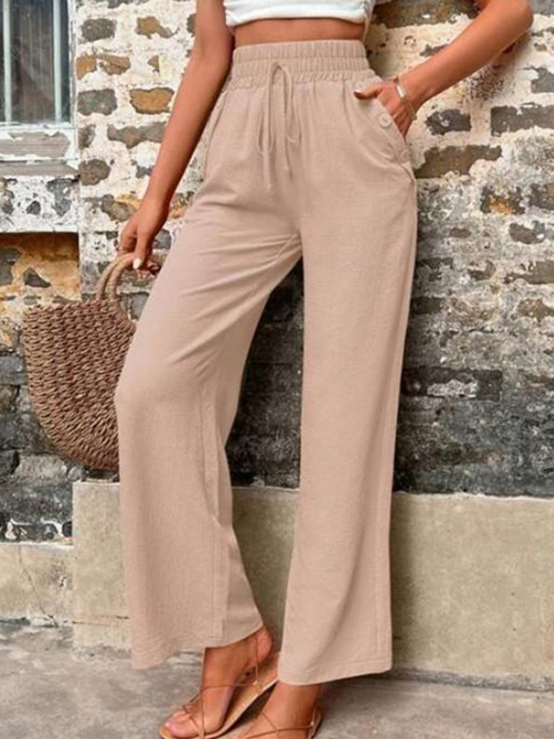 Tied high waist wide leg pants with pockets and decorative buttons, opaque.