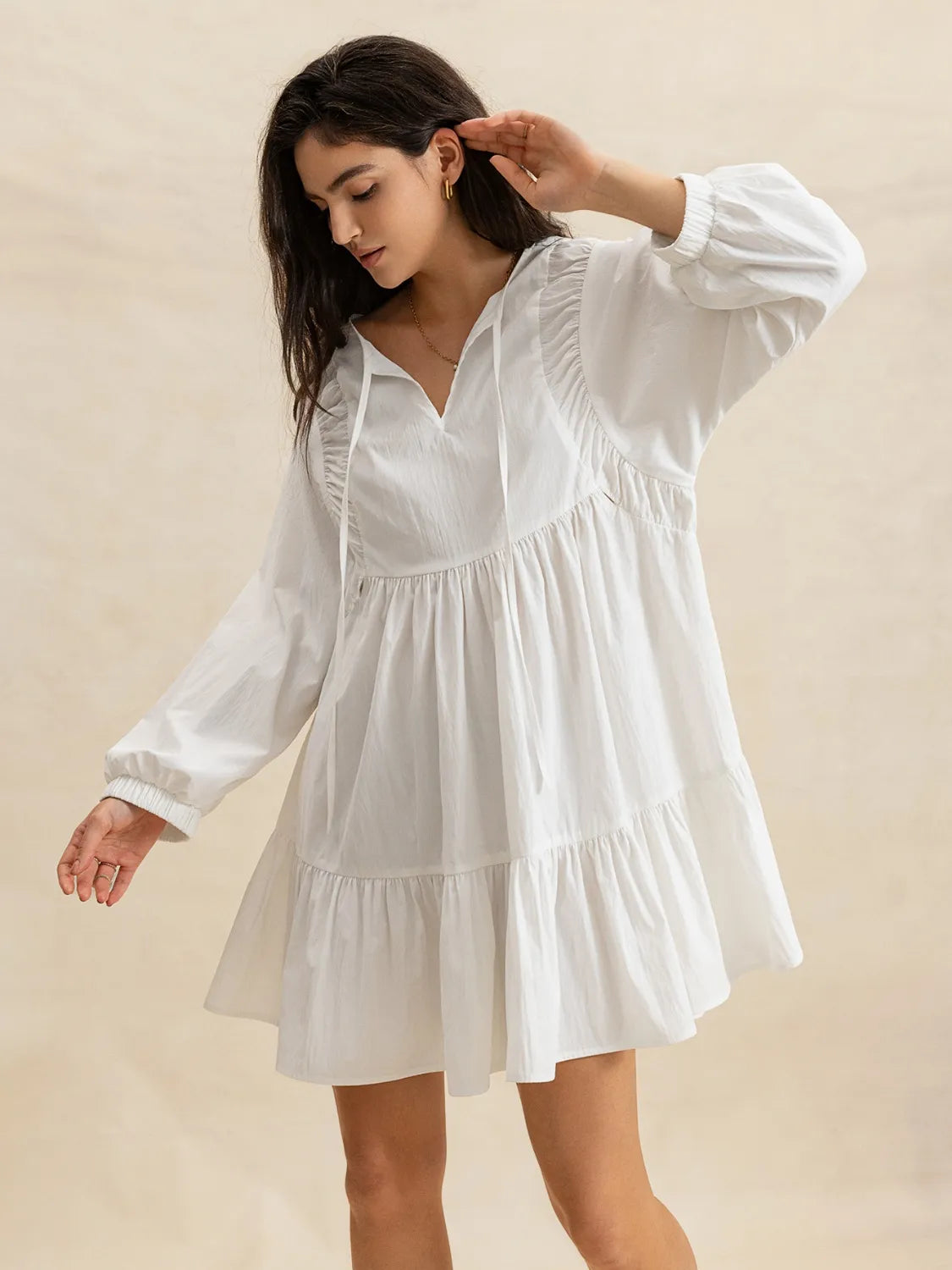 Tiered Tie Neck Long Sleeve Mini Dress.