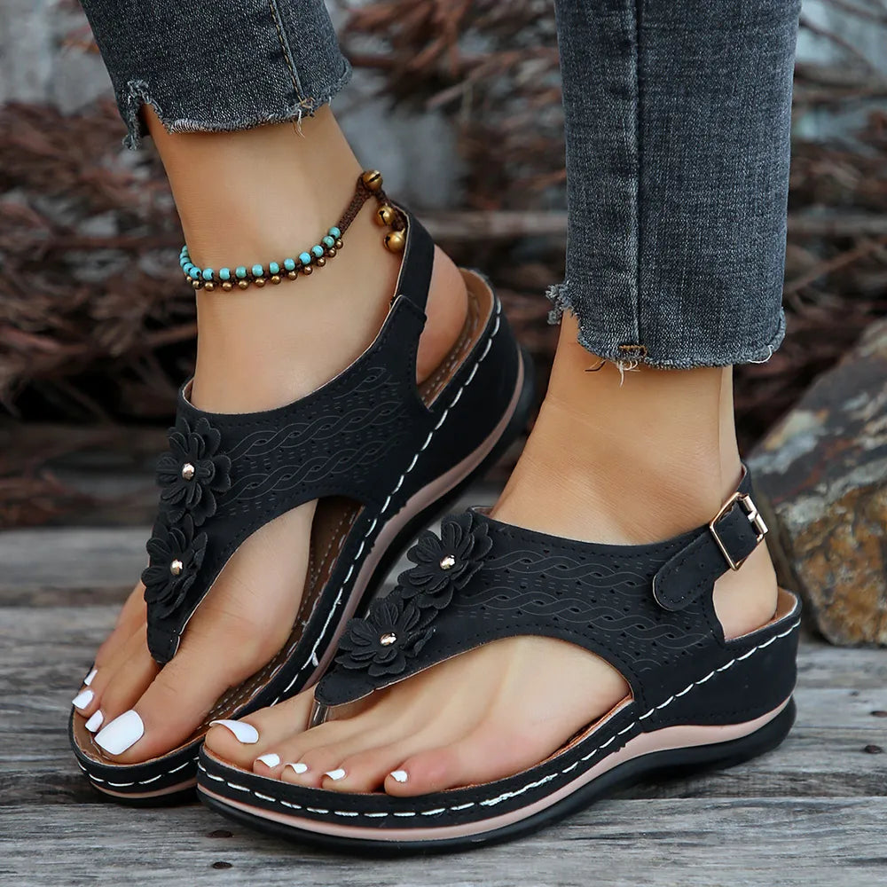 Toe post flower detail mid-heel wedge sandals.