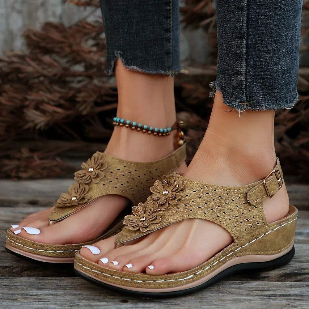 Toe post flower detail mid-heel wedge sandals.