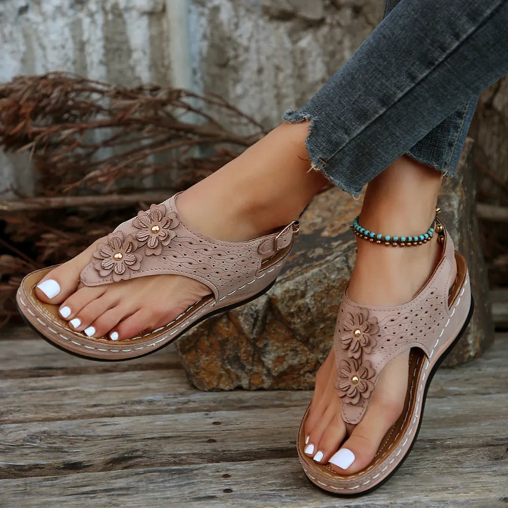 Toe post flower detail mid-heel wedge sandals.