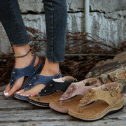 Toe post flower detail mid-heel wedge sandals.