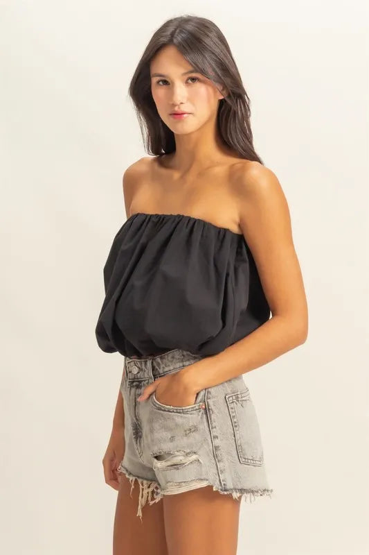 Trendy strapless bubble top with ruched and smocked details, slightly stretchy.