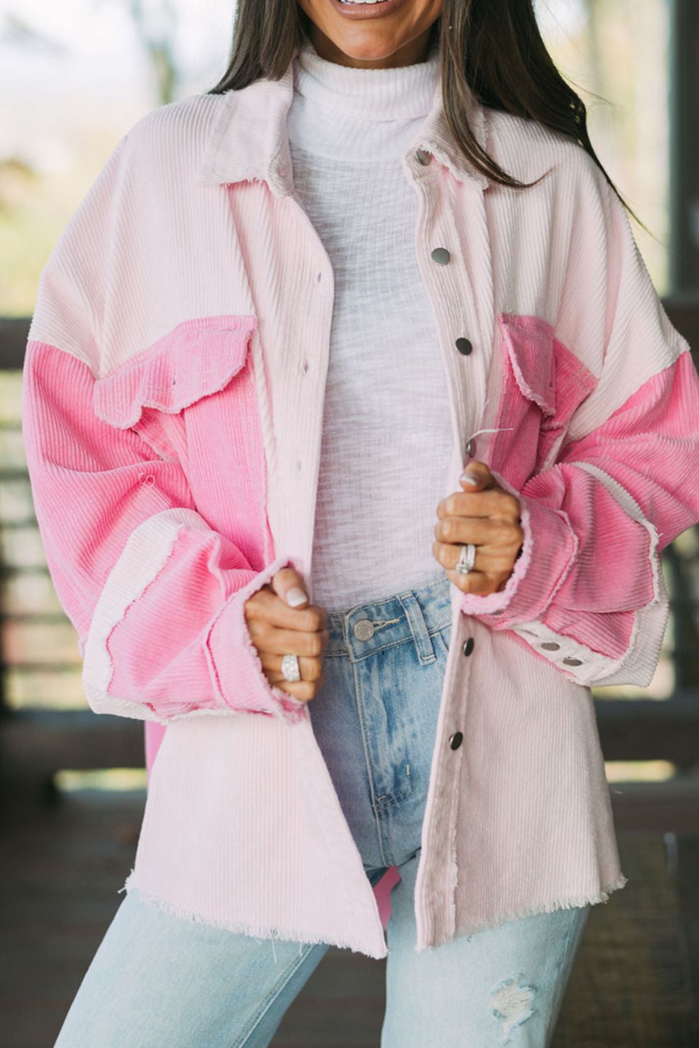 Two-tone exposed seam corduroy shacket with pockets, raw hem, and buttons.